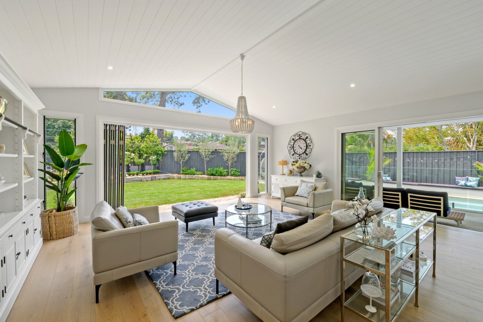 This is an example of a beach style family room in Sydney.