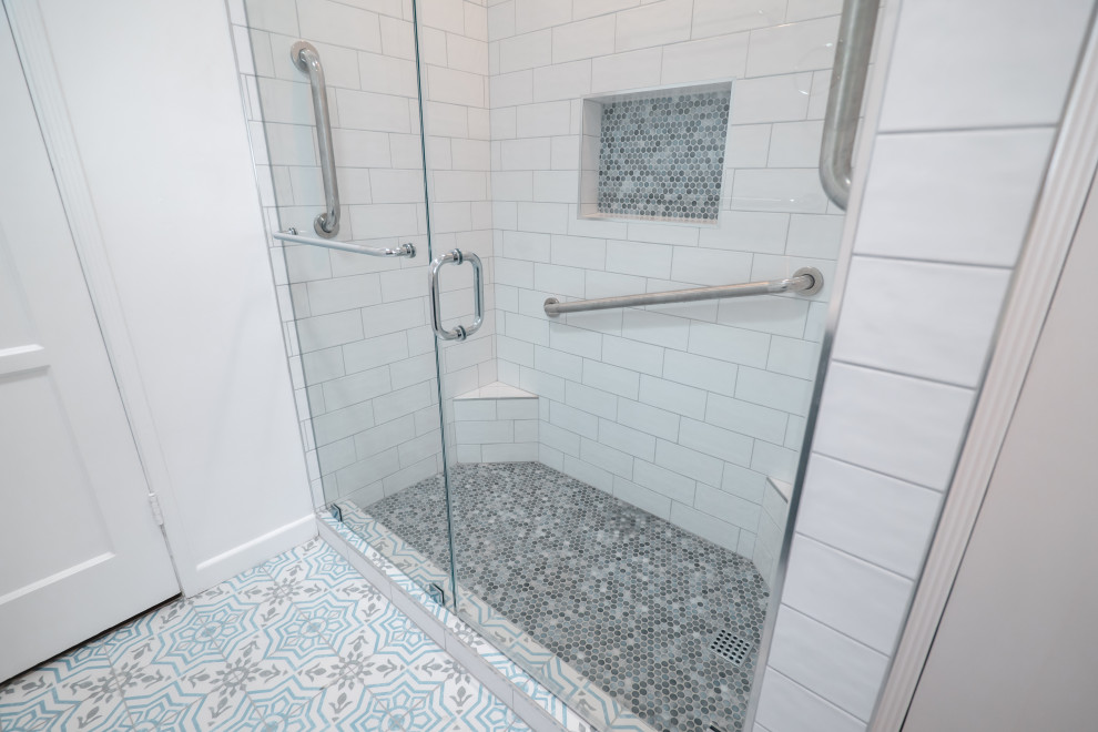 Medium sized modern shower room bathroom in Los Angeles with raised-panel cabinets, brown cabinets, a corner shower, a one-piece toilet, white tiles, metro tiles, white walls, cement flooring, quartz worktops, blue floors, a hinged door, white worktops, a wall niche, a single sink and a built in vanity unit.