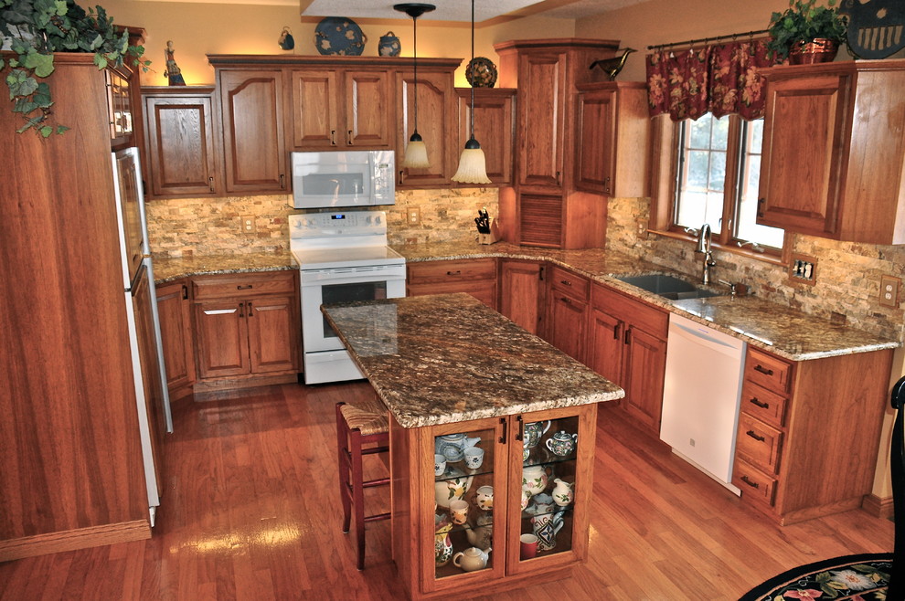 Kitchen - kitchen idea with an undermount sink, granite countertops and stone tile backsplash