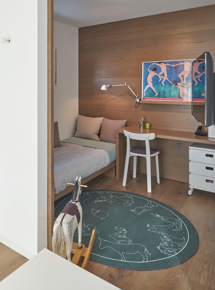 Design ideas for a contemporary gender-neutral kids' playroom for kids 4-10 years old in Berlin with white walls, medium hardwood floors and brown floor.