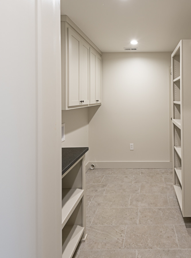Inspiration for a mid-sized transitional galley ceramic tile and beige floor laundry room remodel with shaker cabinets, beige cabinets, beige walls and a side-by-side washer/dryer