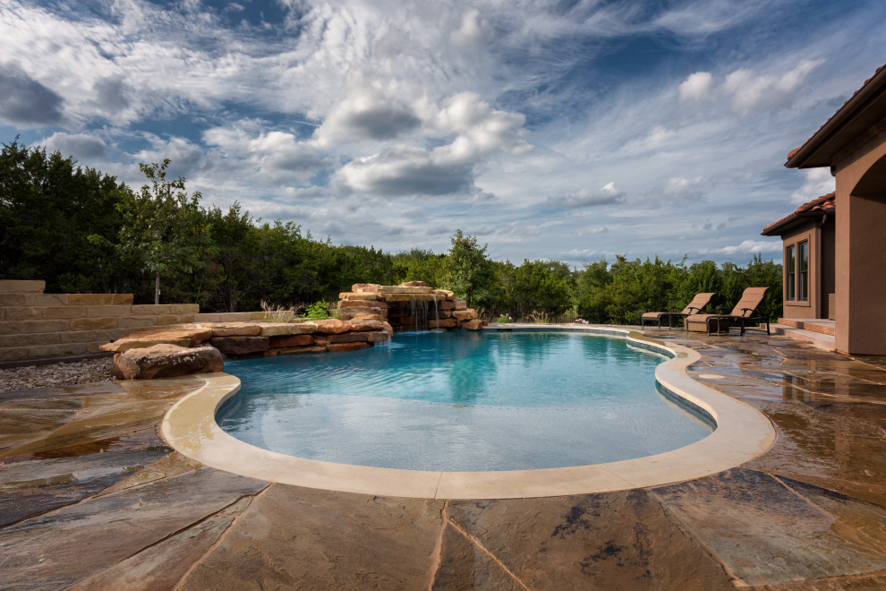Mountain style stone pool landscaping photo in Austin