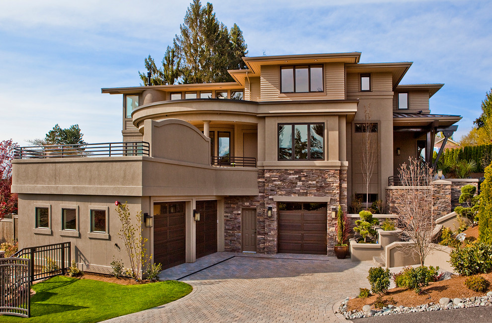Inspiration for a large contemporary three-storey stucco brown house exterior in Seattle with a flat roof.