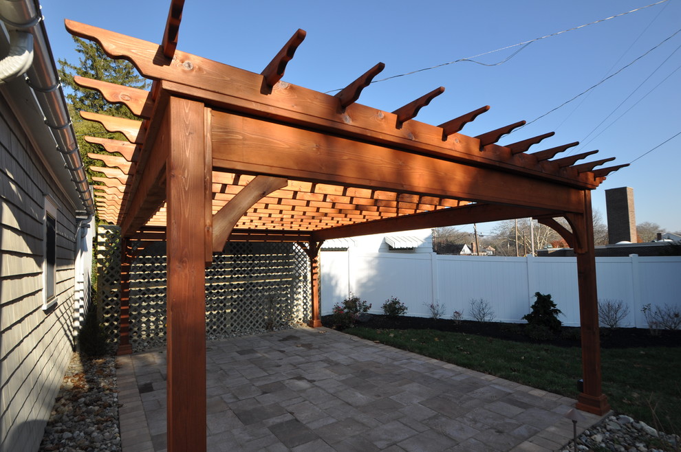 Inspiration for a timeless backyard concrete paver patio remodel with a pergola