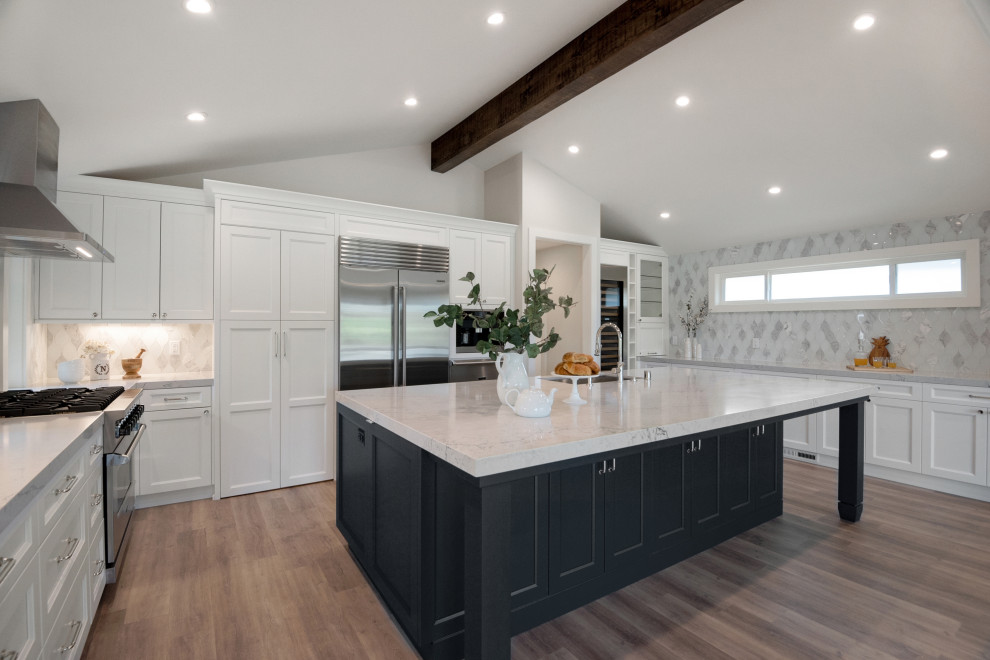 Kitchen pantry - transitional vaulted ceiling kitchen pantry idea in San Francisco with recessed-panel cabinets, white cabinets, quartz countertops, white backsplash, glass tile backsplash, stainless steel appliances and white countertops