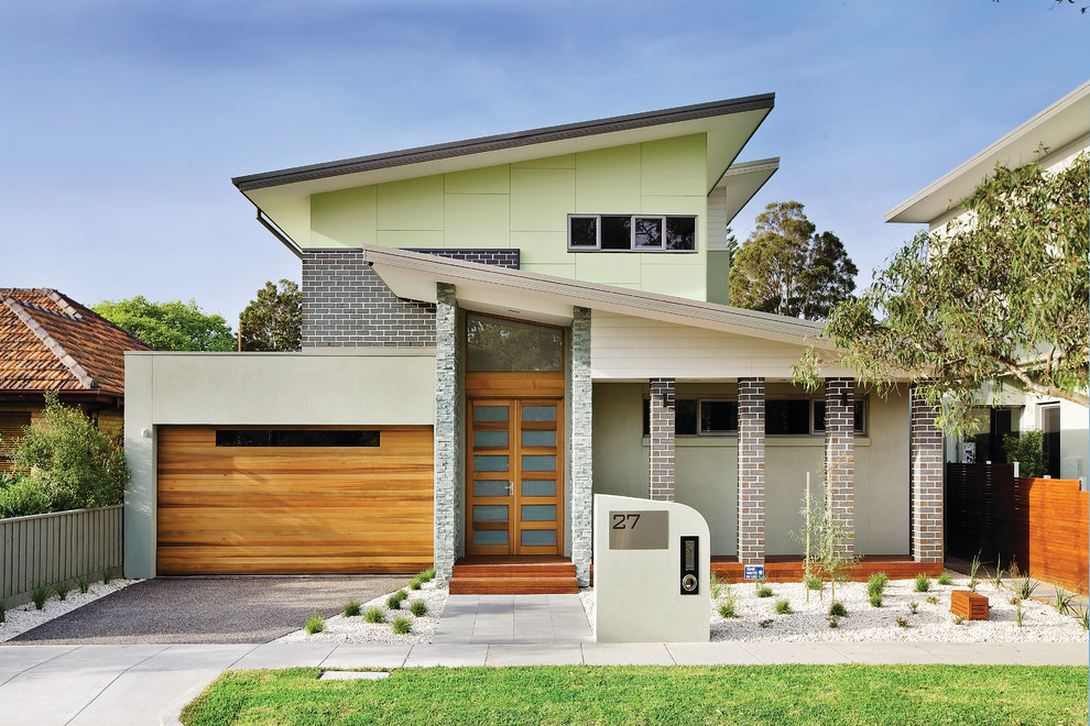Photo of a contemporary two-storey multi-coloured house exterior in Melbourne with a shed roof.