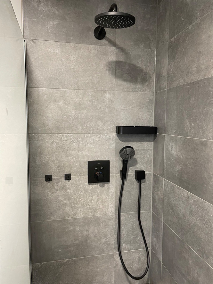Стильный дизайн: серо-белая ванная комната в современном стиле с душем без бортиков, полом из цементной плитки, серым полом, открытым душем и каменной плиткой - последний тренд