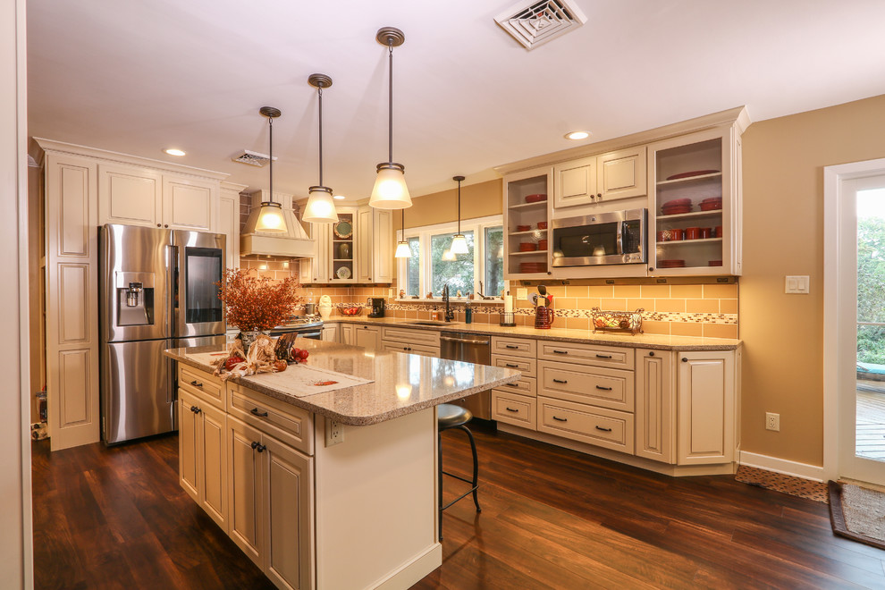 Inspiration for a mid-sized transitional u-shaped vinyl floor and brown floor eat-in kitchen remodel with an undermount sink, raised-panel cabinets, beige cabinets, quartz countertops, brown backsplash, porcelain backsplash, stainless steel appliances and an island