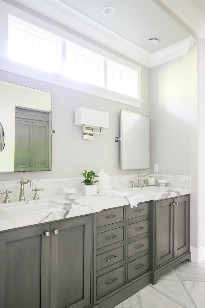 This is an example of a traditional master bathroom in Orange County with shaker cabinets, grey cabinets, grey walls, an undermount sink and grey floor.