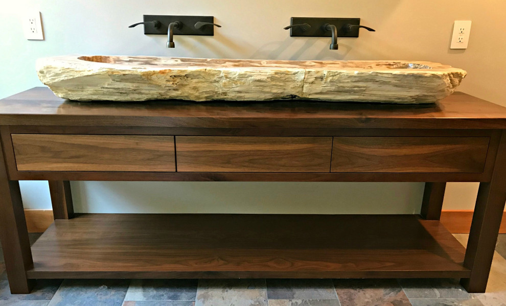 This is an example of a large country master bathroom in Philadelphia with furniture-like cabinets, medium wood cabinets, slate floors, a vessel sink, wood benchtops and grey floor.