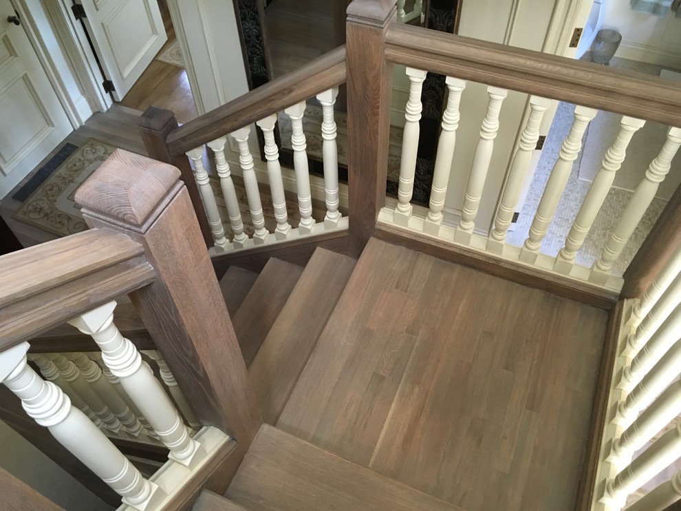 This is an example of a traditional wood curved staircase in Los Angeles with wood risers.
