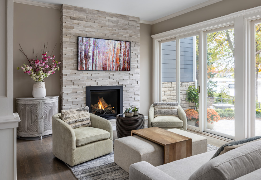 Photo of a medium sized traditional open plan living room in Detroit with brown walls, medium hardwood flooring, a standard fireplace, a stacked stone fireplace surround, a wall mounted tv and brown floors.