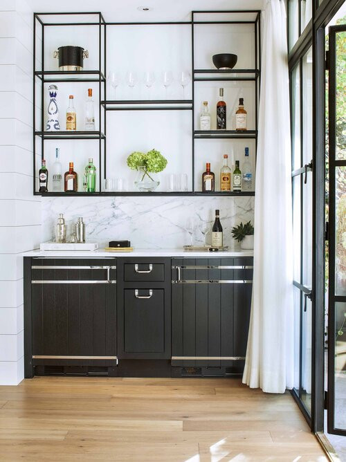 Photo of a mid-sized contemporary galley bar cart in Denver with an undermount sink, flat-panel cabinets, black cabinets, quartz benchtops, medium hardwood floors and white benchtop.