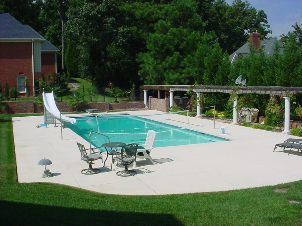 Inspiration for a backyard concrete and custom-shaped lap pool fountain remodel