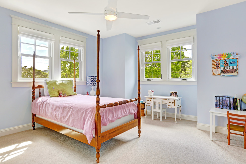 This is an example of a traditional kids' bedroom for girls in San Francisco with carpet and blue walls.