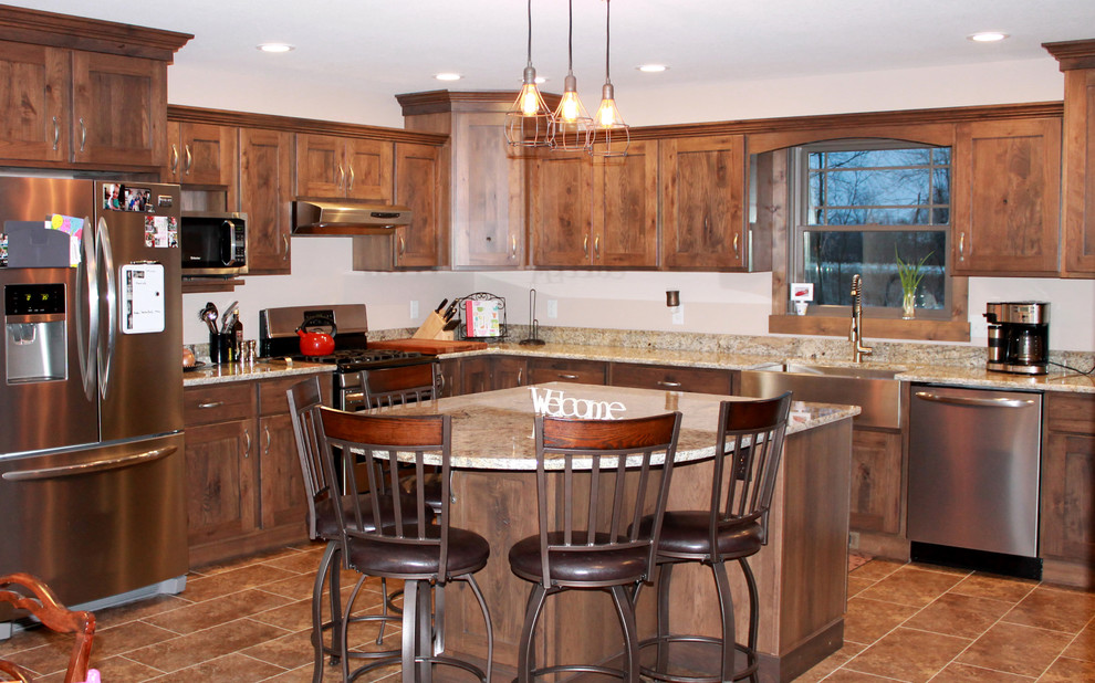Inspiration for a large rustic l-shaped eat-in kitchen remodel in Chicago with a farmhouse sink, shaker cabinets, dark wood cabinets, granite countertops, stainless steel appliances and an island