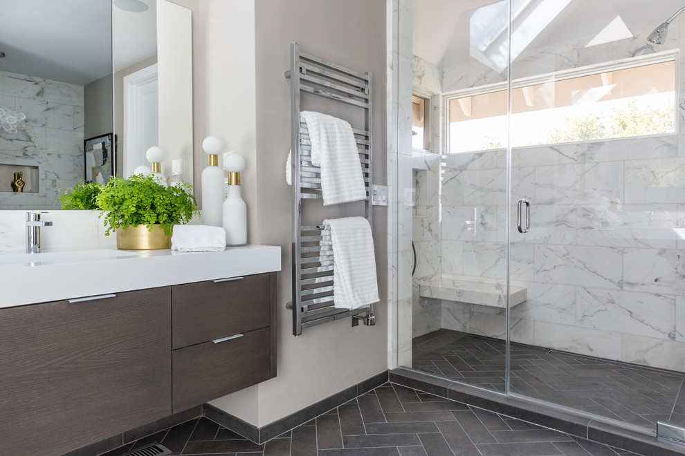 Design ideas for a contemporary bathroom in San Francisco with flat-panel cabinets, white cabinets, an alcove shower, white tile, grey walls, an integrated sink, grey floor, a hinged shower door and white benchtops.