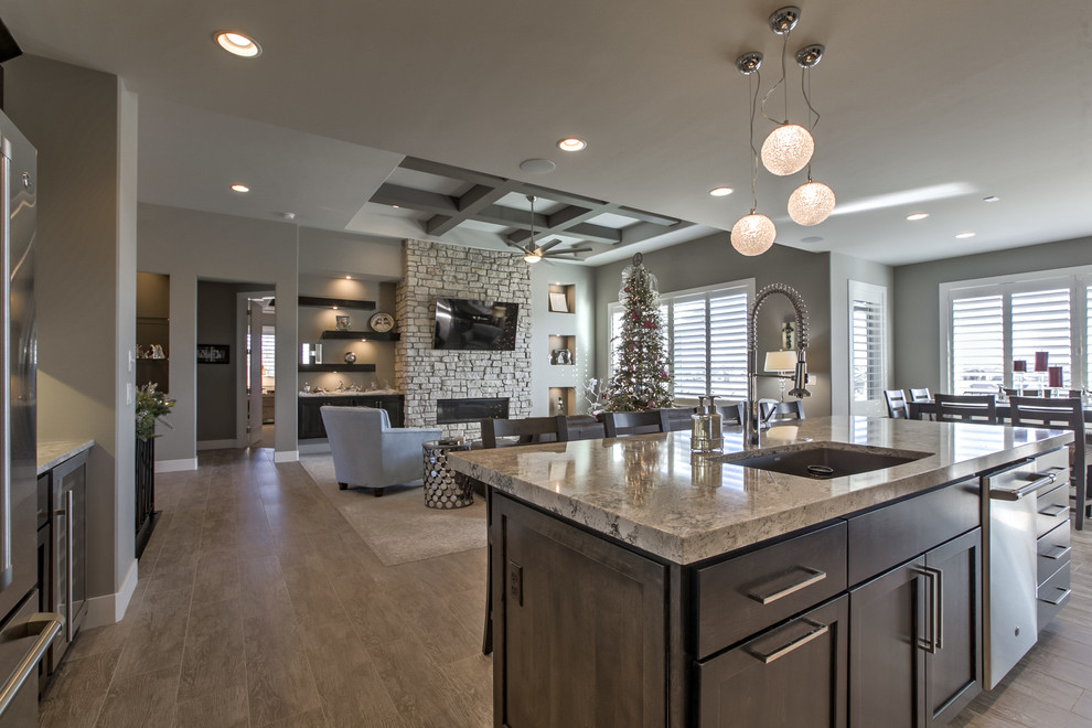 Transitional porcelain tile open concept kitchen photo in Omaha with an undermount sink, shaker cabinets, dark wood cabinets, granite countertops, white backsplash, mosaic tile backsplash, stainless steel appliances and an island