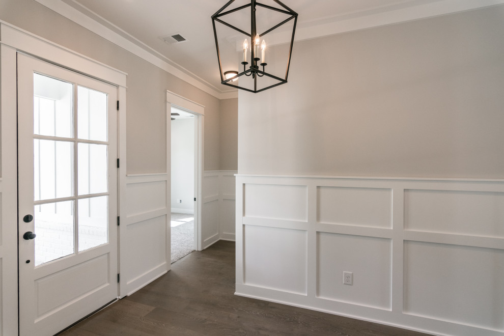 Photo of a mid-sized country foyer in Nashville with grey walls, vinyl floors, a single front door, a glass front door and brown floor.
