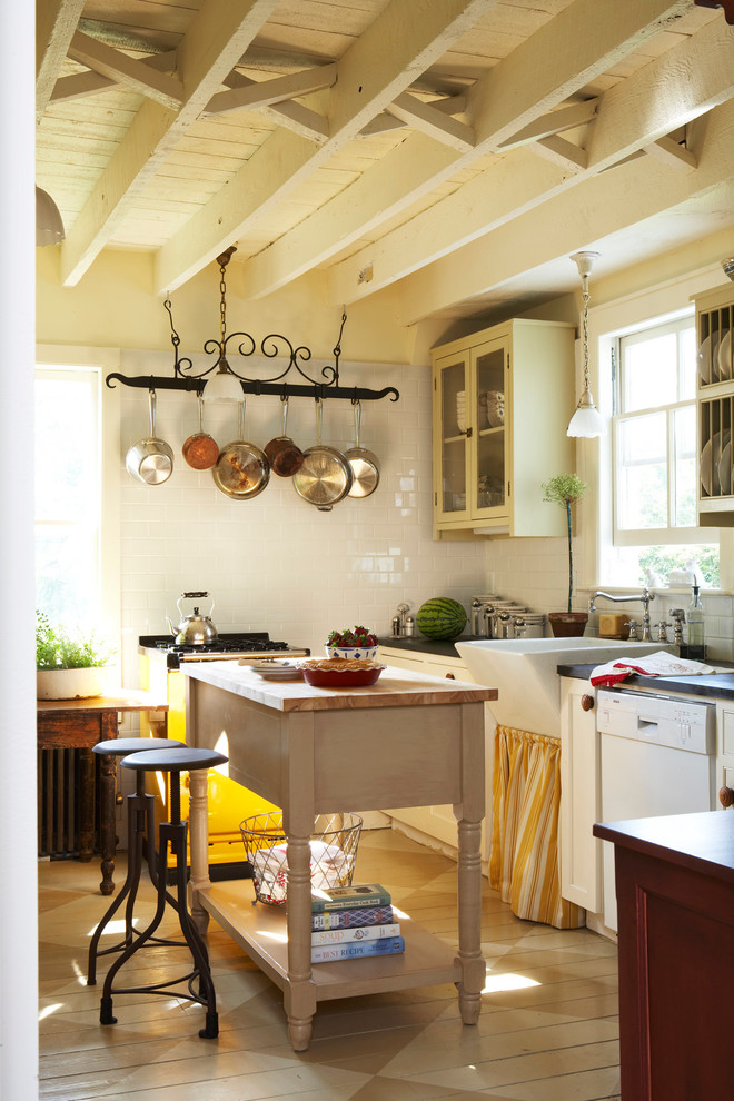 Photo of a mid-sized country l-shaped eat-in kitchen in Other with a farmhouse sink, glass-front cabinets, beige cabinets, white splashback, subway tile splashback, with island and white appliances.