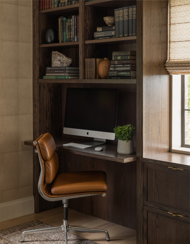 Photo of a small transitional study room in Seattle with beige walls, light hardwood floors, no fireplace, a built-in desk and beige floor.