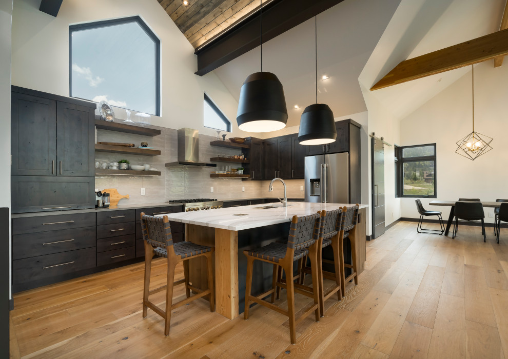Medium sized contemporary l-shaped open plan kitchen in Denver with shaker cabinets, grey cabinets, white splashback, stainless steel appliances, light hardwood flooring, an island, white worktops and a timber clad ceiling.