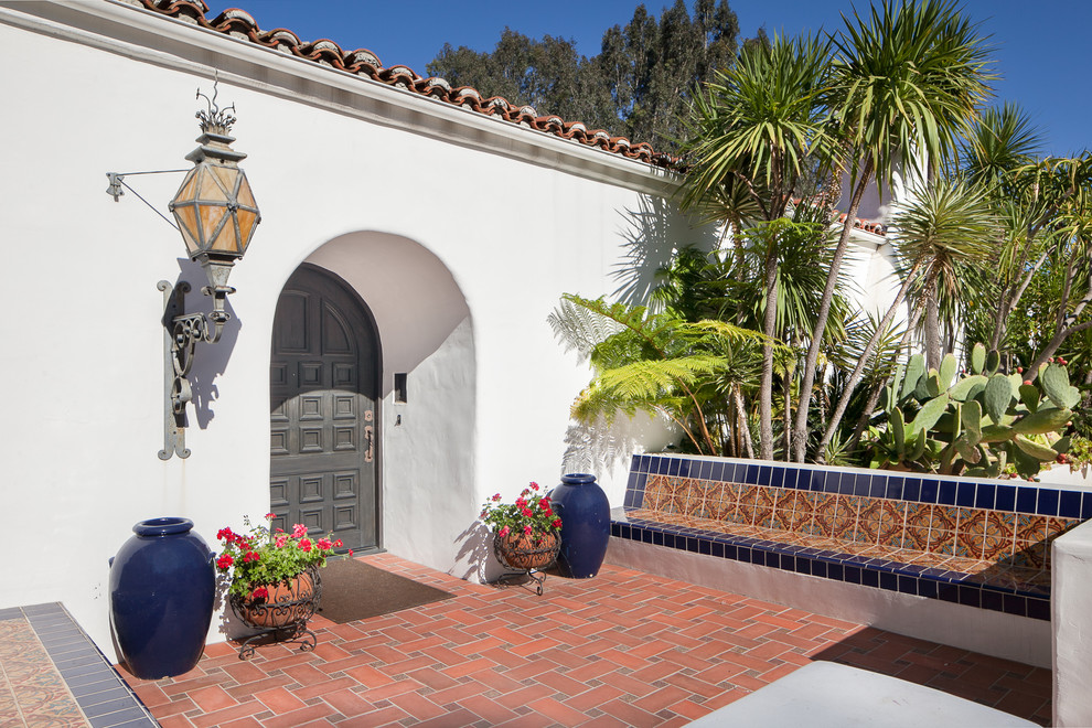 Photo of a mediterranean entryway in Los Angeles with a single front door and a gray front door.