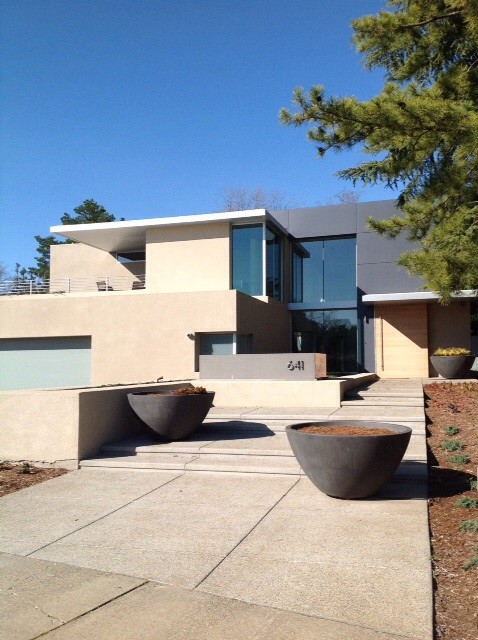 Inspiration for a large modern two-storey stucco multi-coloured exterior in Sacramento with a flat roof.