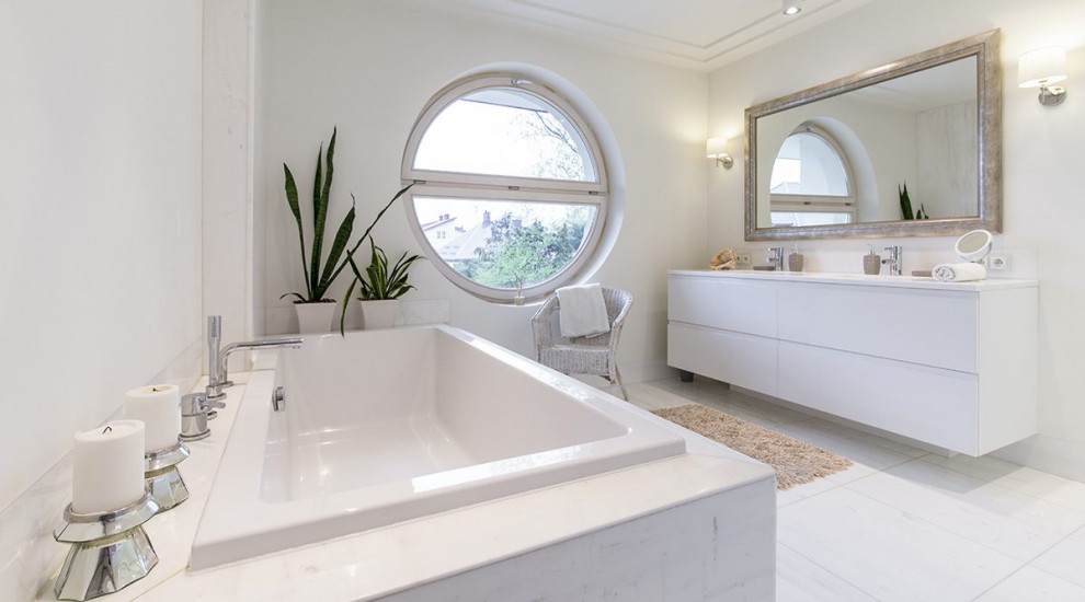 Inspiration for a mid-sized contemporary 3/4 bathroom in Barcelona with flat-panel cabinets, white cabinets, a drop-in tub, grey walls, an undermount sink, white floor, white benchtops, a double vanity and a floating vanity.