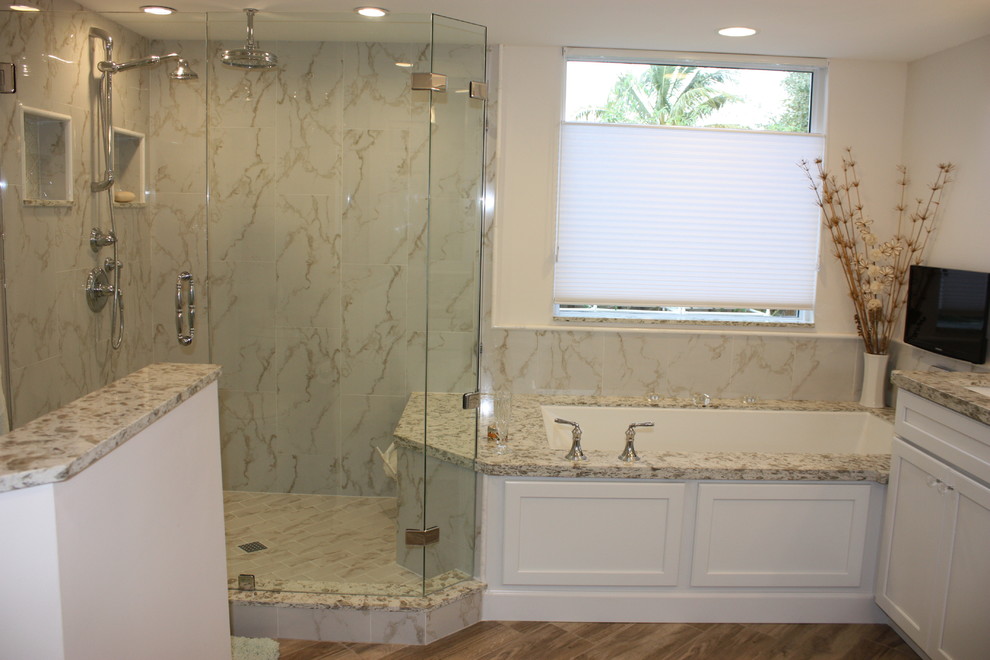 Mid-sized transitional master bathroom in Miami with shaker cabinets, white cabinets, an undermount tub, a corner shower, a one-piece toilet, white tile, porcelain tile, white walls, porcelain floors, engineered quartz benchtops and an undermount sink.