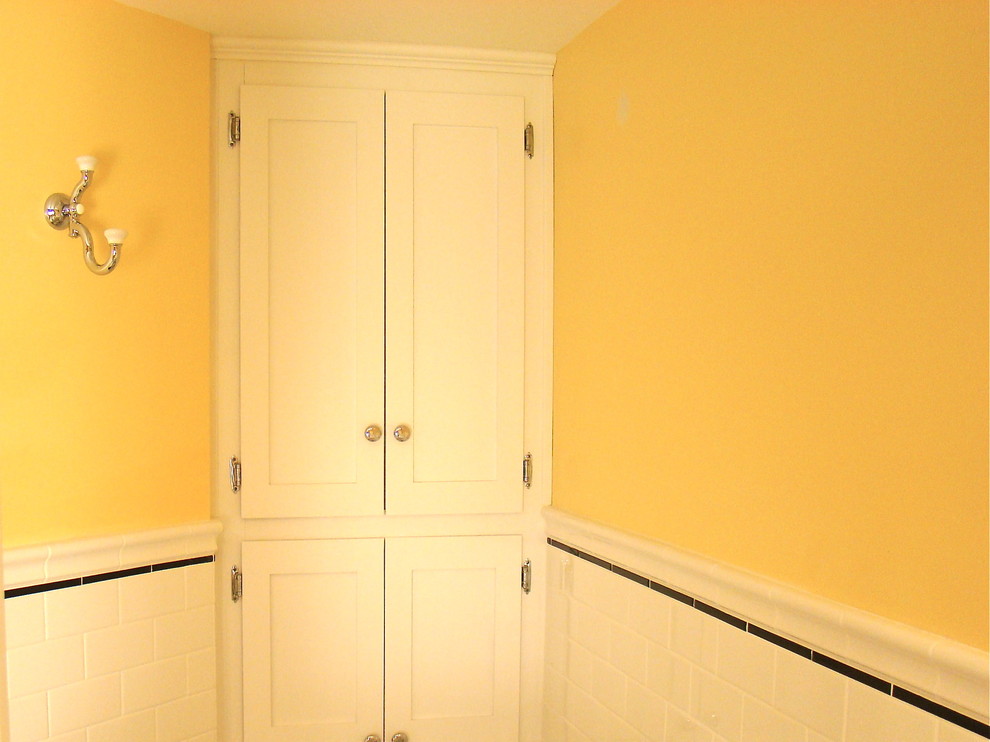 Mid-sized traditional fully buried basement in Minneapolis with yellow walls and porcelain floors.