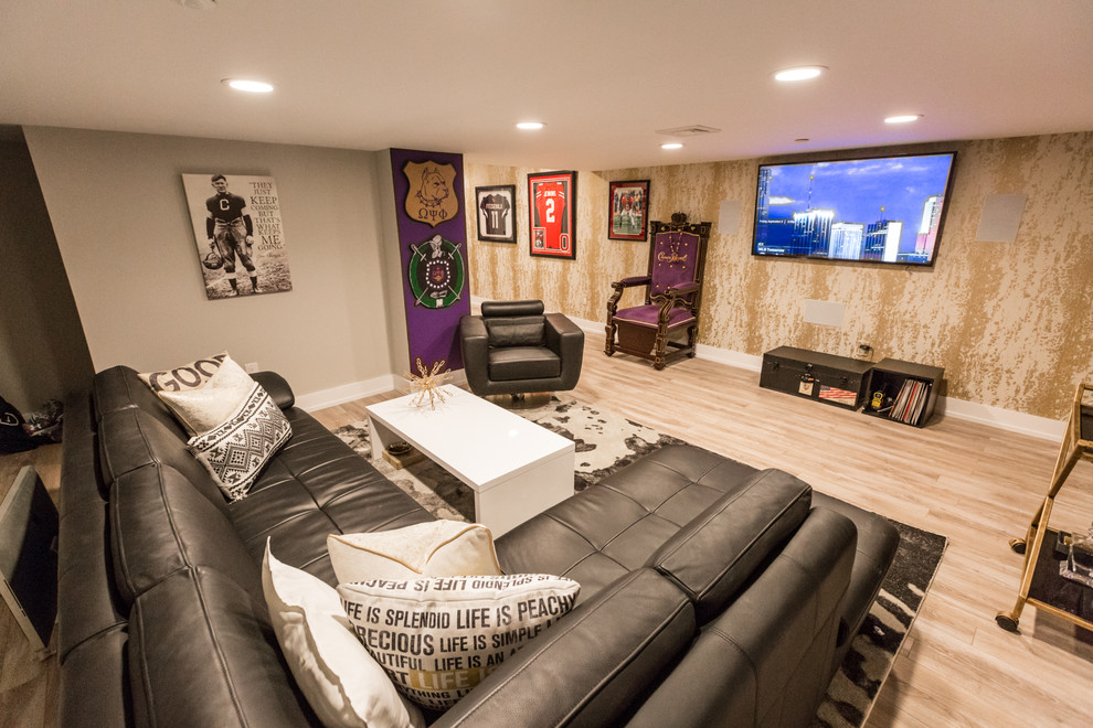 This is an example of an expansive modern walk-out basement in Philadelphia with purple walls, light hardwood floors and beige floor.