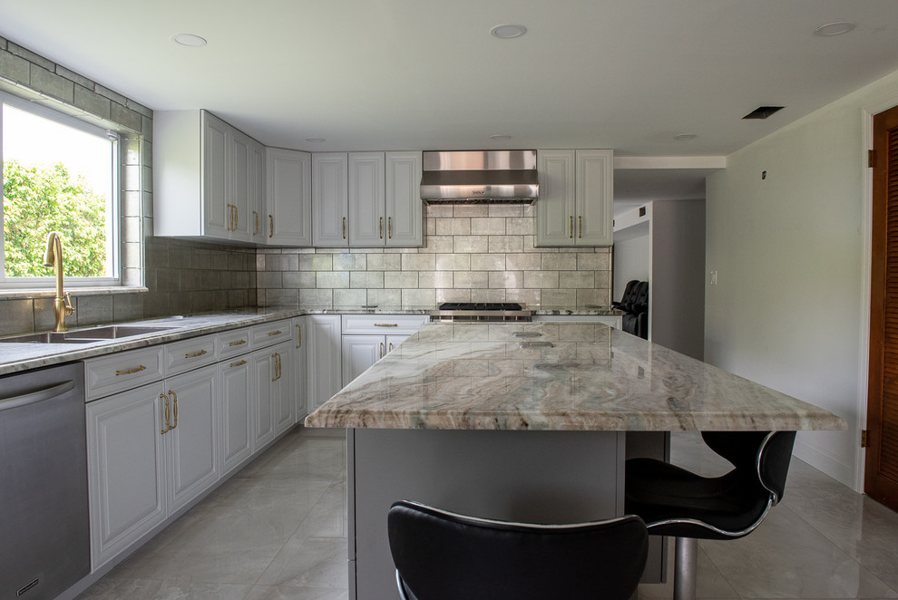 Inspiration for a large transitional u-shaped eat-in kitchen in Miami with quartzite benchtops and multiple islands.
