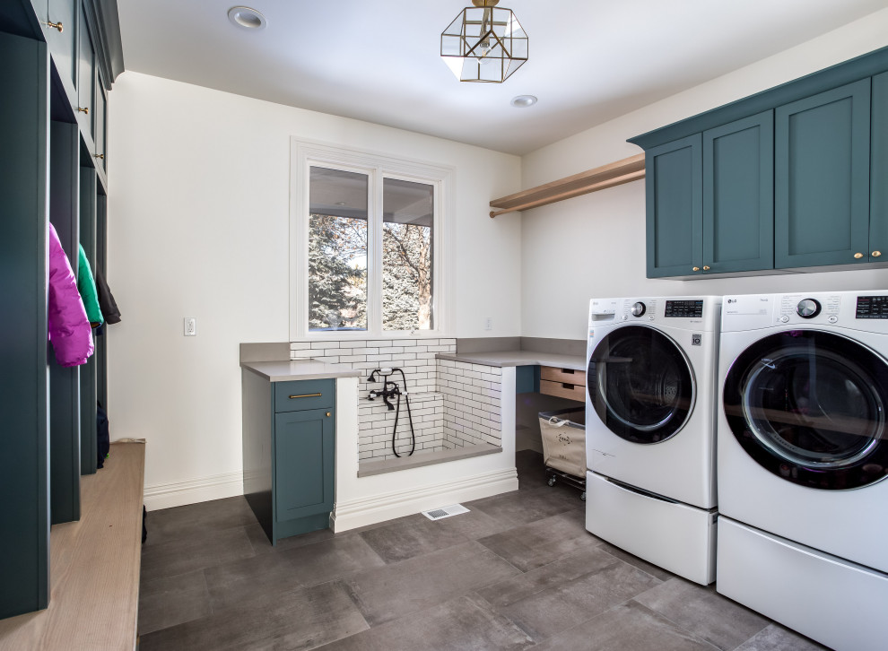 Large traditional u-shaped dedicated laundry room in Denver with shaker cabinets, turquoise cabinets, quartzite benchtops, beige splashback, engineered quartz splashback, white walls, porcelain floors, a side-by-side washer and dryer, grey floor and beige benchtop.