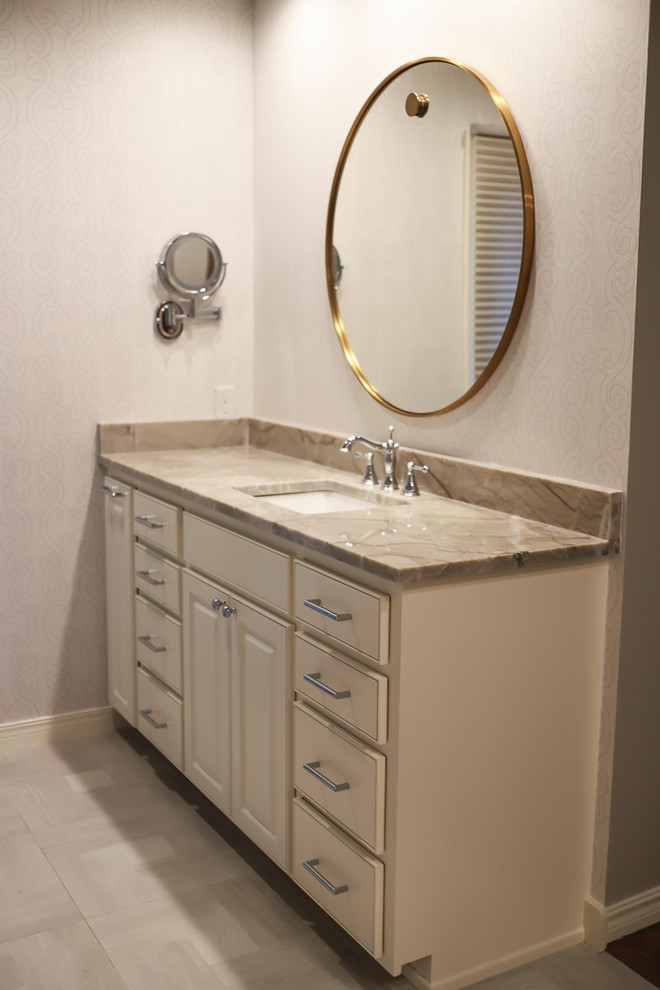 Example of a mid-sized transitional master white tile and marble tile ceramic tile and gray floor alcove bathtub design with gray walls, beaded inset cabinets, white cabinets, a two-piece toilet, an undermount sink, quartzite countertops and a hinged shower door