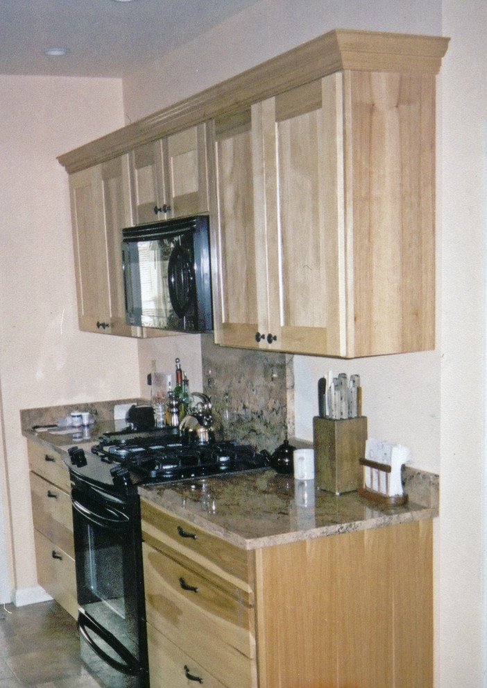Example of a small transitional galley ceramic tile and brown floor kitchen design with an undermount sink, shaker cabinets, light wood cabinets, marble countertops, brown backsplash, marble backsplash, black appliances, no island and brown countertops