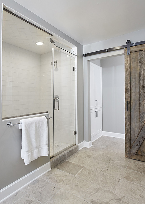 Inspiration for a mid-sized country master bathroom in Grand Rapids with a freestanding tub, an alcove shower and grey walls.