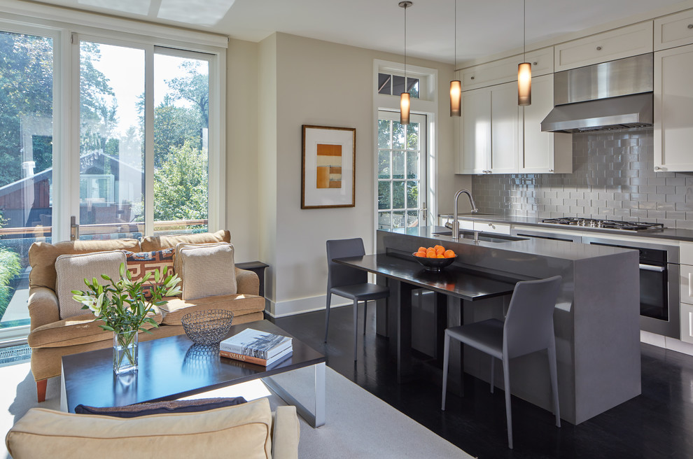 Photo of a mid-sized contemporary single-wall open plan kitchen in DC Metro with beige cabinets, quartz benchtops, grey splashback, glass tile splashback, stainless steel appliances, dark hardwood floors, brown floor, an undermount sink, shaker cabinets and with island.