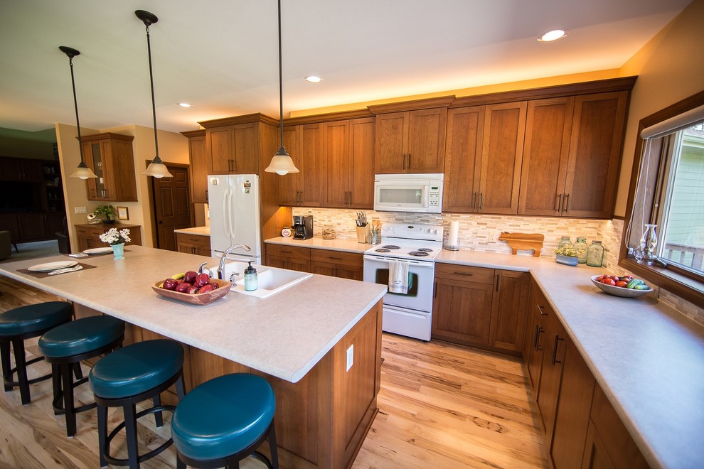 Inspiration for a large transitional l-shaped light wood floor eat-in kitchen remodel in Cedar Rapids with a double-bowl sink, recessed-panel cabinets, medium tone wood cabinets, laminate countertops, multicolored backsplash, mosaic tile backsplash, white appliances and an island