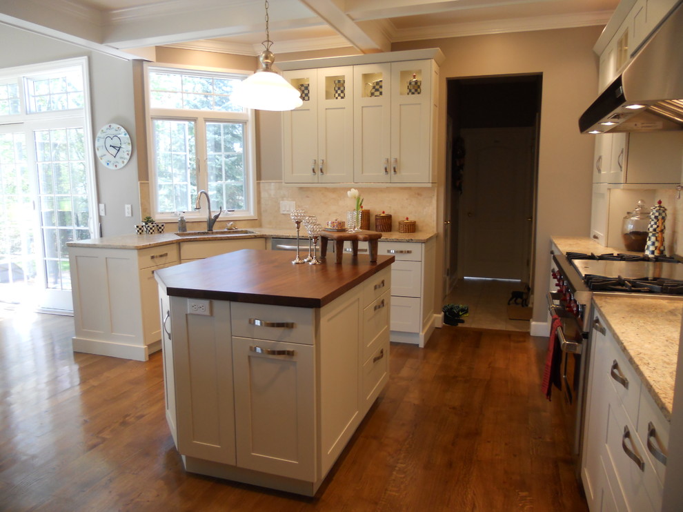 Large transitional u-shaped medium tone wood floor eat-in kitchen photo in New York with an undermount sink, recessed-panel cabinets, white cabinets, granite countertops, multicolored backsplash, porcelain backsplash, stainless steel appliances, gray walls and an island