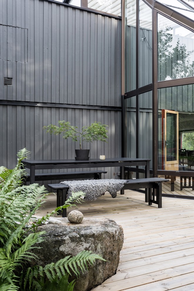 Inspiration for a mid-sized scandinavian side yard deck in Stockholm with no cover.