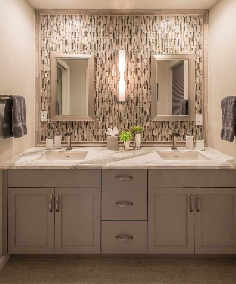 Photo of a small transitional master bathroom in Phoenix with shaker cabinets, grey cabinets, a two-piece toilet, gray tile, mirror tile, a drop-in sink and marble benchtops.