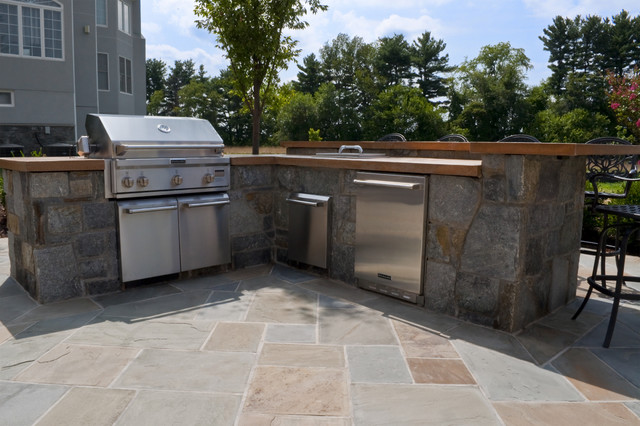 Stone Based Outdoor Kitchen With Concrete Countertops