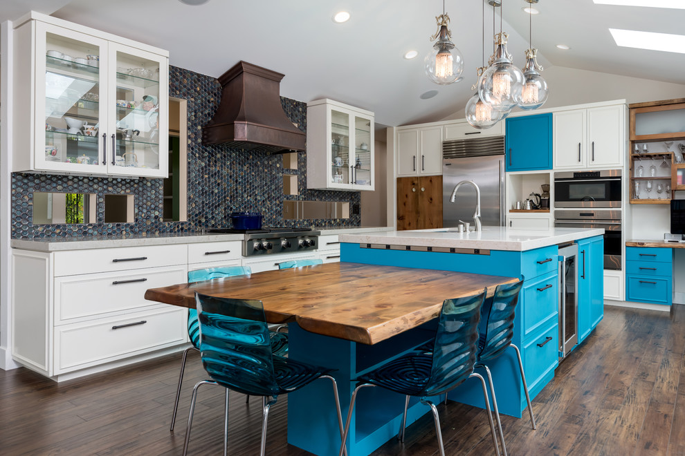 Photo of a large eclectic l-shaped open plan kitchen in San Francisco with an undermount sink, beaded inset cabinets, turquoise cabinets, quartz benchtops, blue splashback, mosaic tile splashback, stainless steel appliances, laminate floors, with island, multi-coloured floor and beige benchtop.