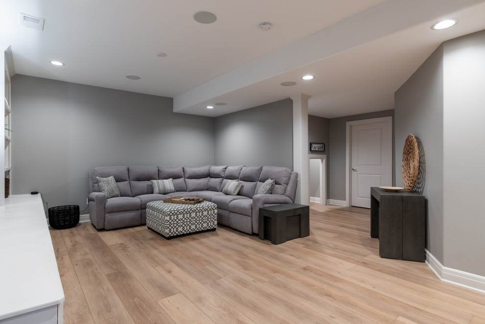 This is an example of a medium sized modern fully buried basement in San Diego with a home cinema, grey walls, vinyl flooring, beige floors and all types of ceiling.