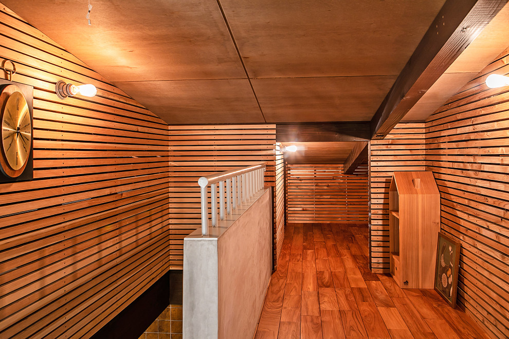 This is an example of an asian hallway in Other with dark hardwood floors, exposed beam and wood walls.