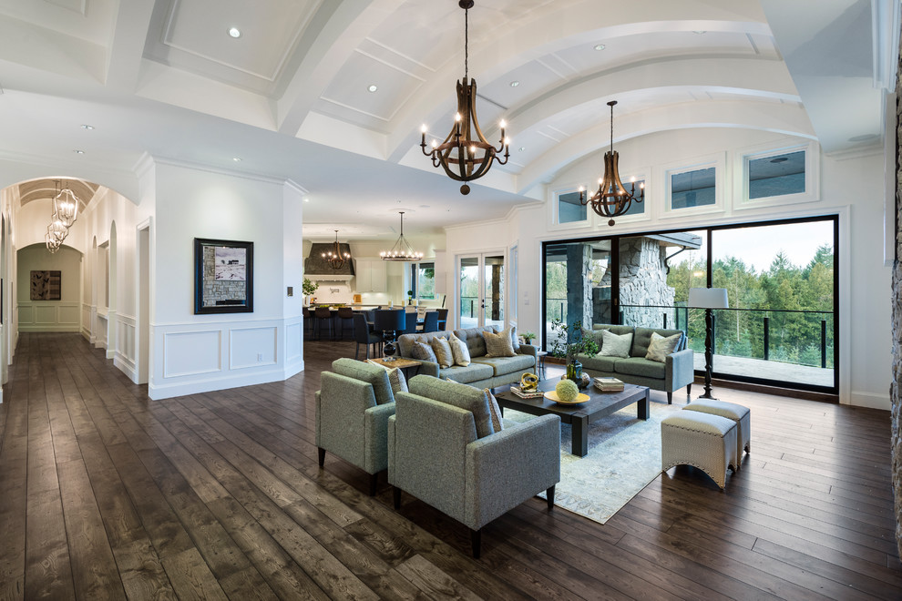 Expansive transitional open concept living room in Vancouver with white walls, medium hardwood floors and brown floor.
