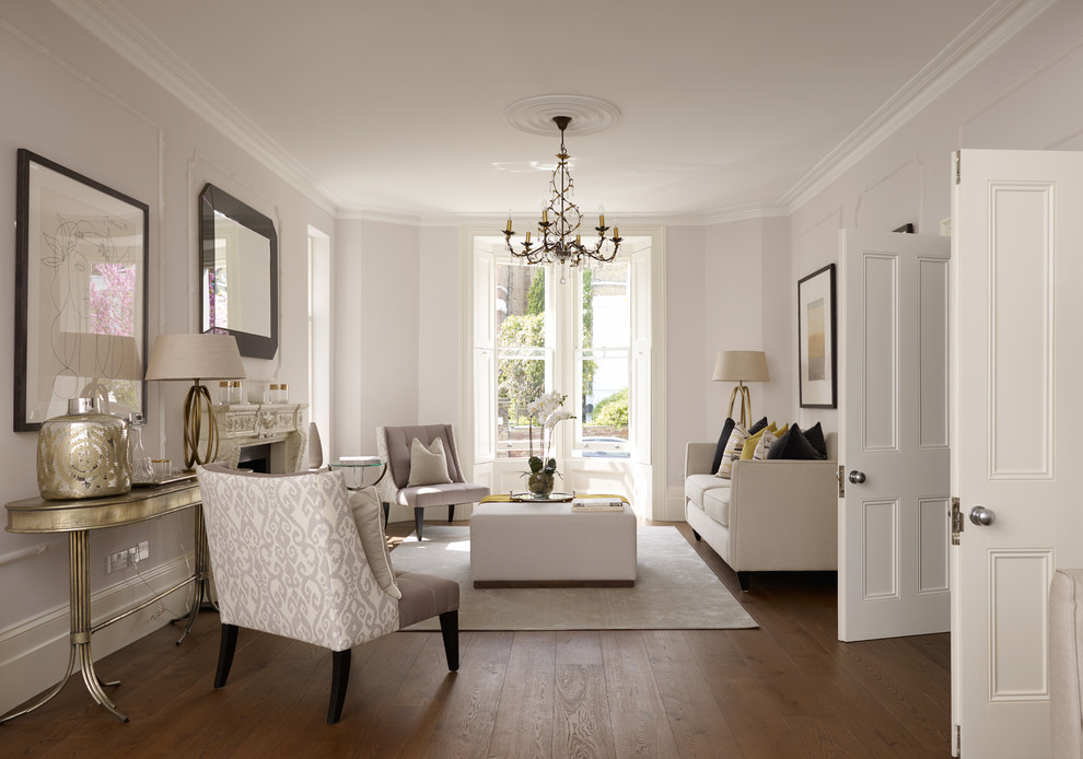 Photo of a transitional living room in London with grey walls and medium hardwood floors.