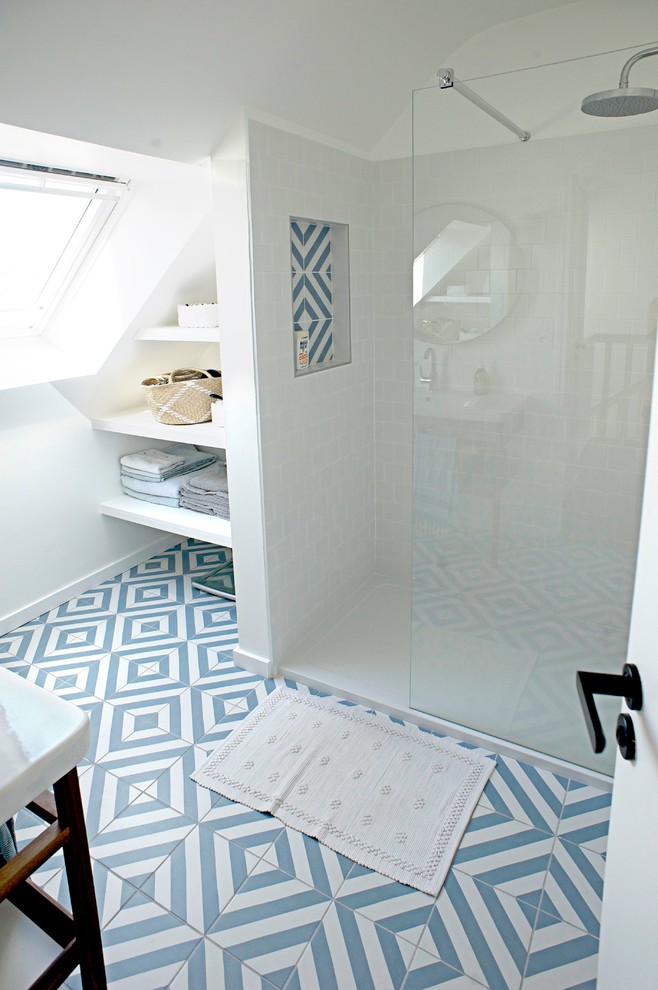 Design ideas for a mid-sized beach style 3/4 bathroom with an open shower, white tile, ceramic tile, white walls, ceramic floors, a console sink, blue floor and a hinged shower door.