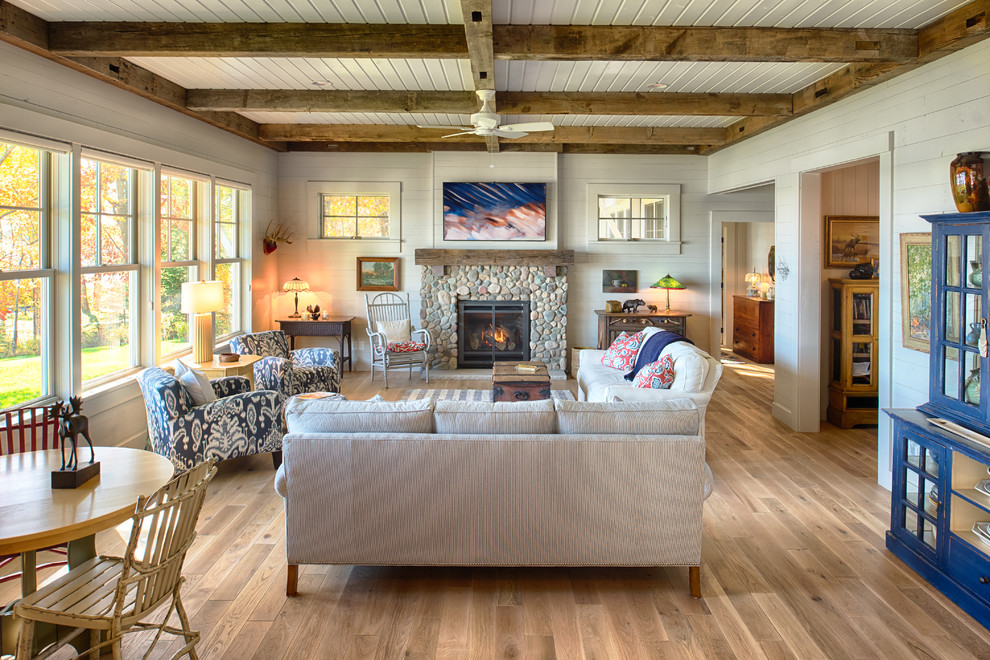 Inspiration for a mid-sized country open concept living room in Minneapolis with white walls, light hardwood floors, a standard fireplace and a stone fireplace surround.